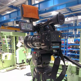 Filmkamera auf dem Stativ im Maschinensaal für den Dreh eines Imagefilms in China